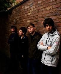 The Fleecers band portrait against a Manchester brick wall